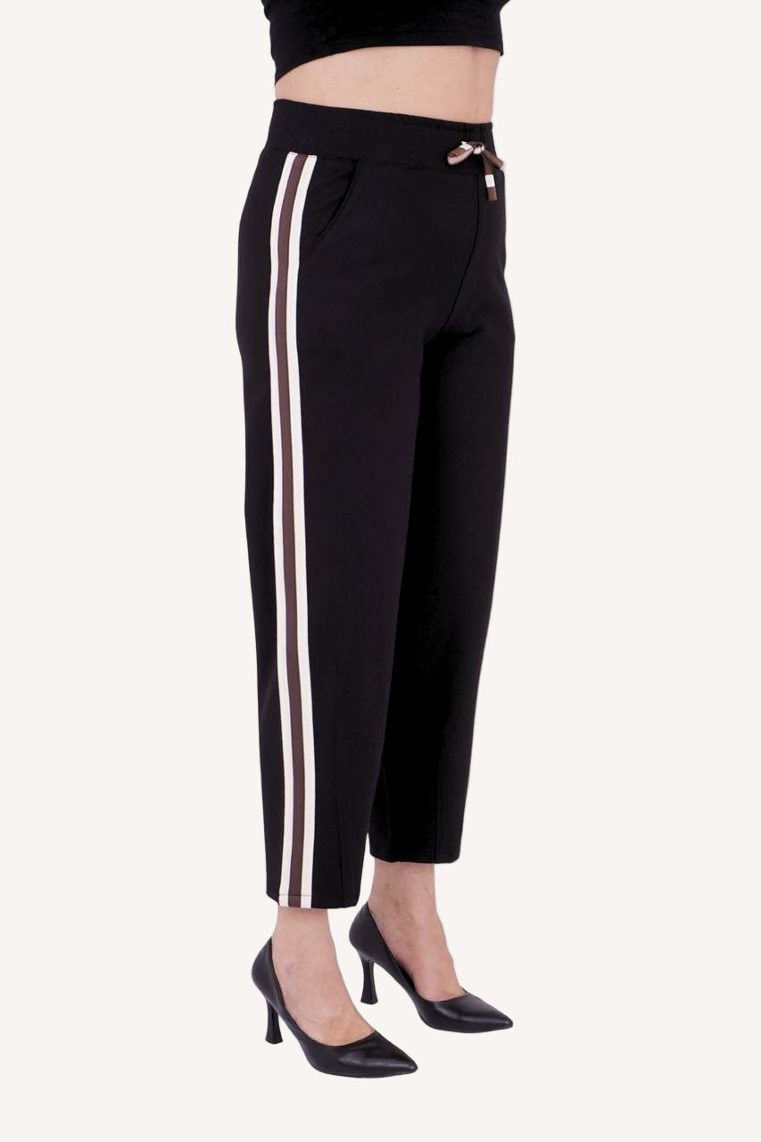 Plus-size model wearing Active & Stylish Luxe Stripe Trousers – black with taupe-gold side stripe
