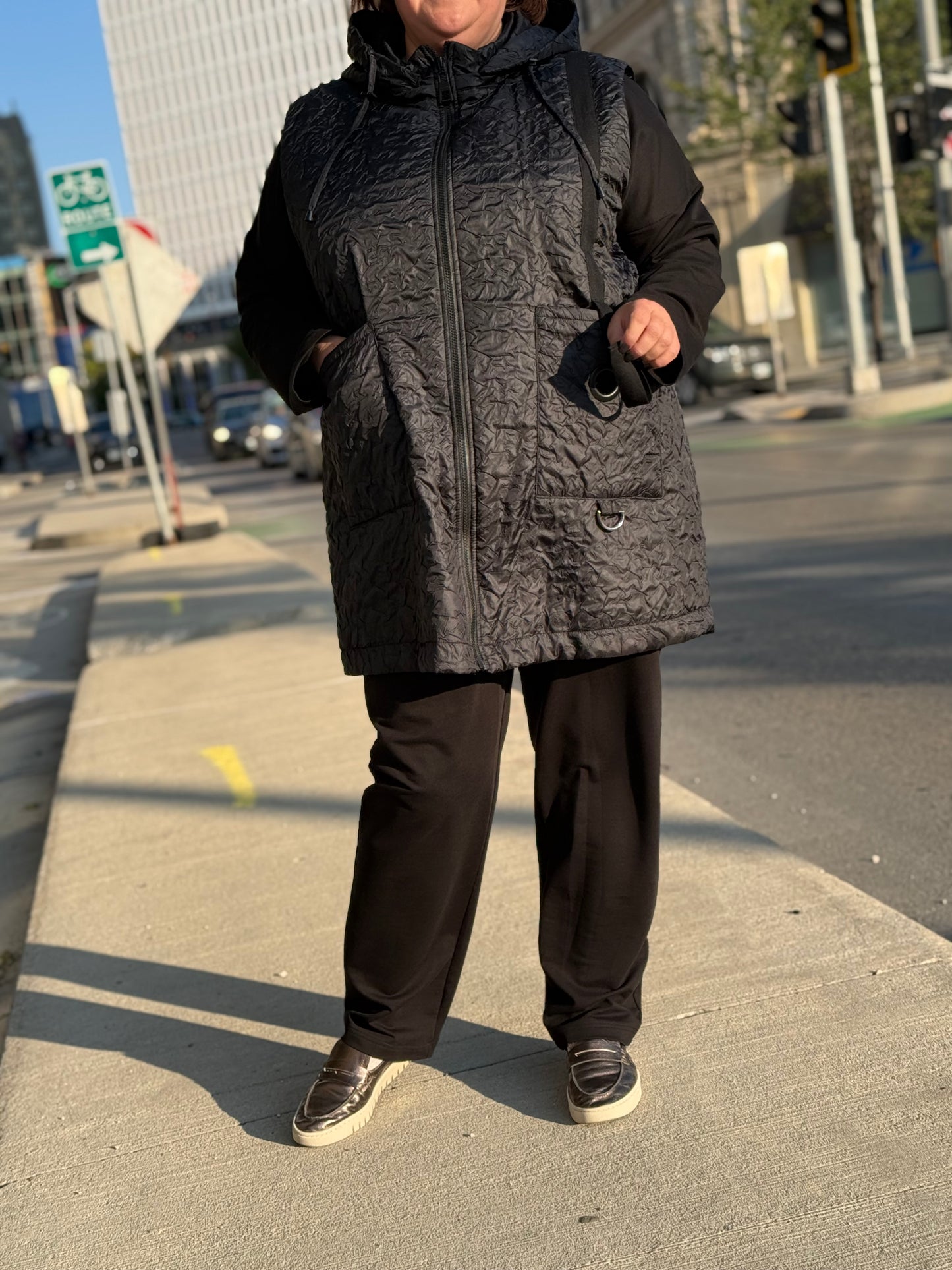 Model walking in downtown Winnipeg wearing City Comfort Suit, 3-piece plus-size outfit.