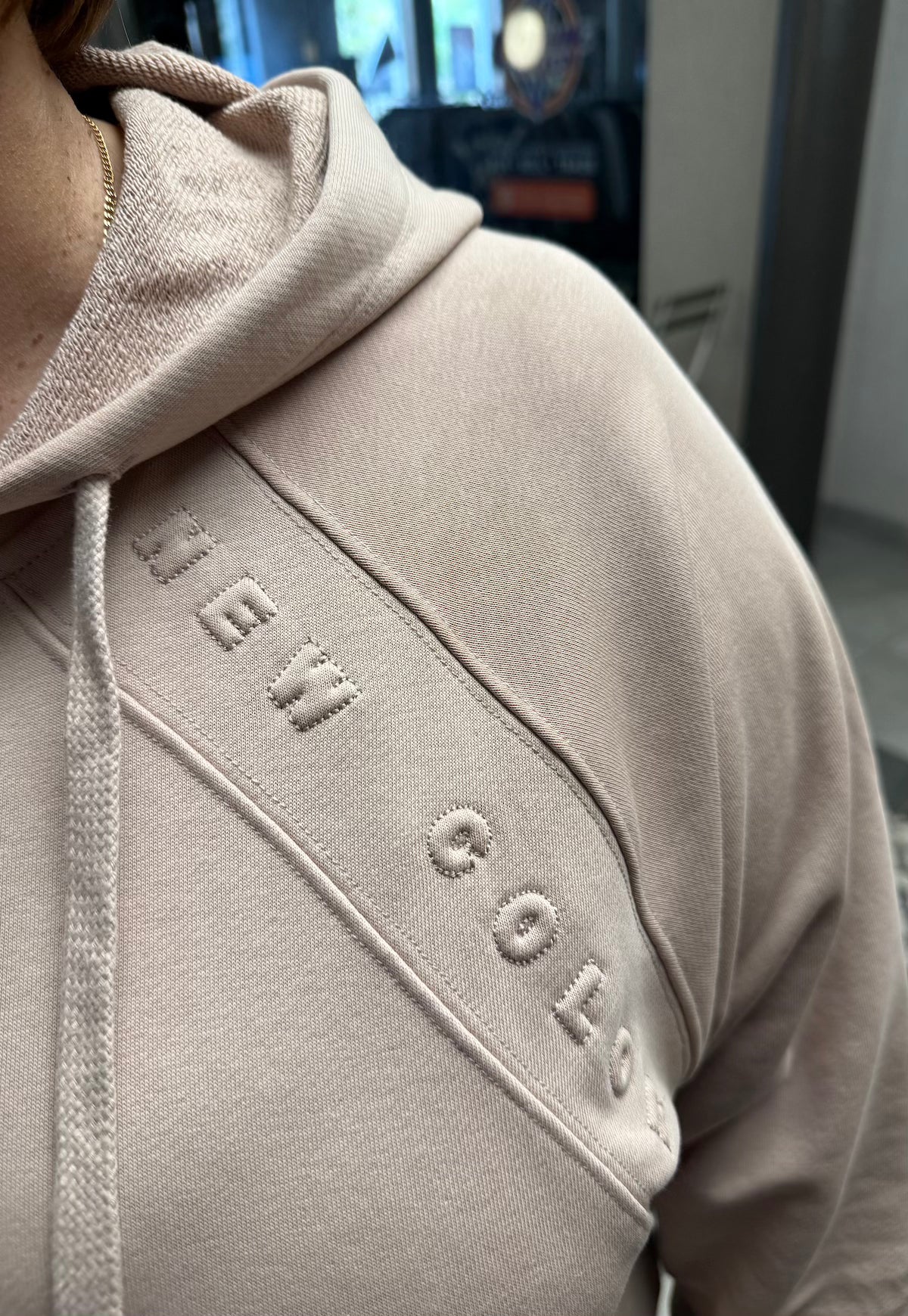 Close-up of hoodie zipper and fabric texture – Powder Taupe double knit.