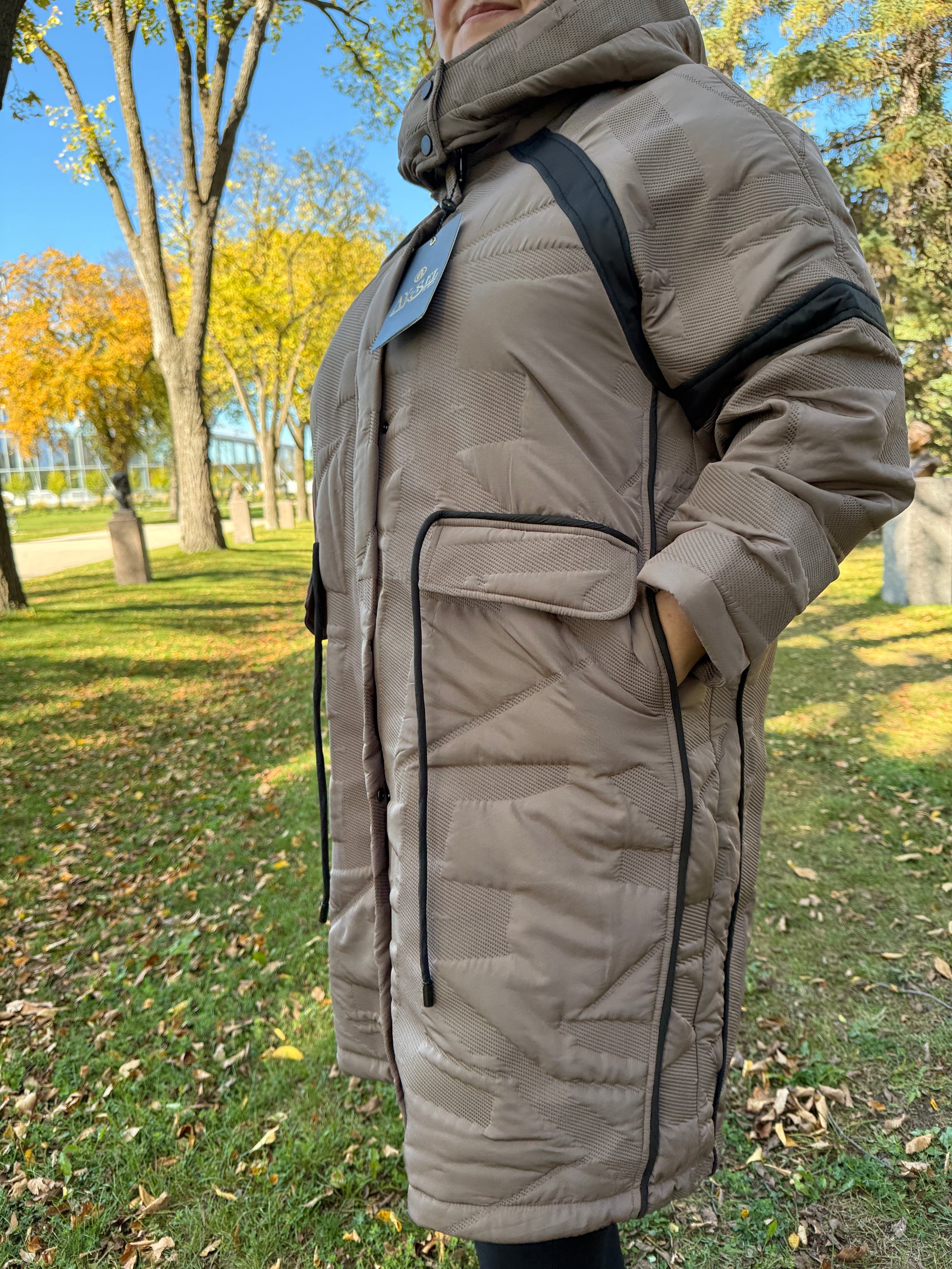 Plus-size model wearing City Chic Taupe Glow Winter Coat – taupe beige with black details By Zola
